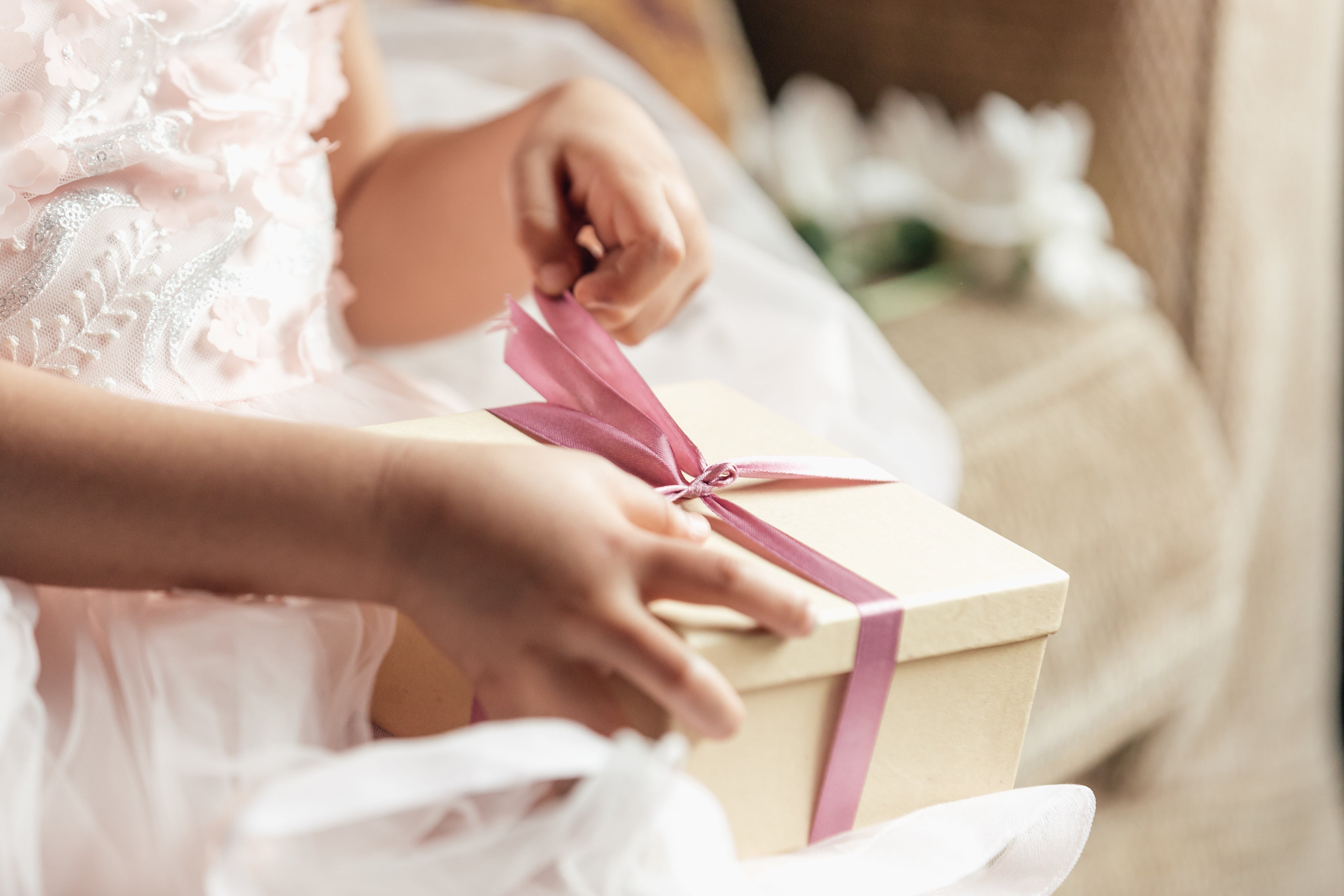 girl or daughter opening gift present surprise